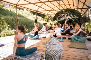 Wellness retreat Portugal – morning yoga class on outdoor wooden deck Monchique