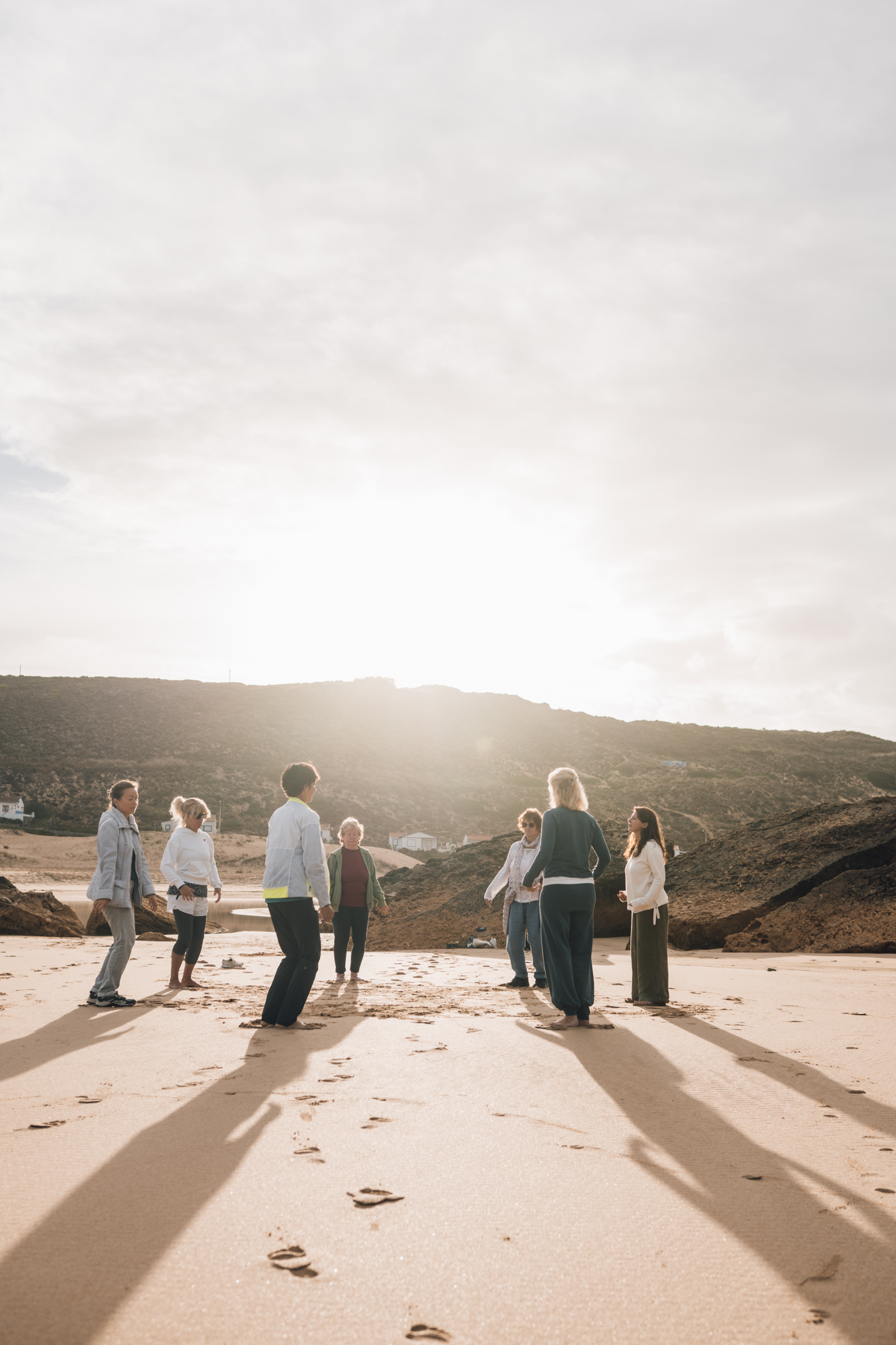 Retreat event Algarve – group sharing circle on the beach at sunset