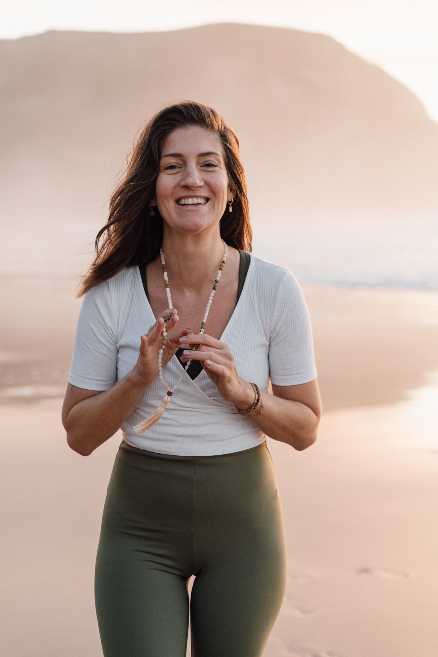 Personal branding photography Algarve – smiling yoga teacher with mala beads